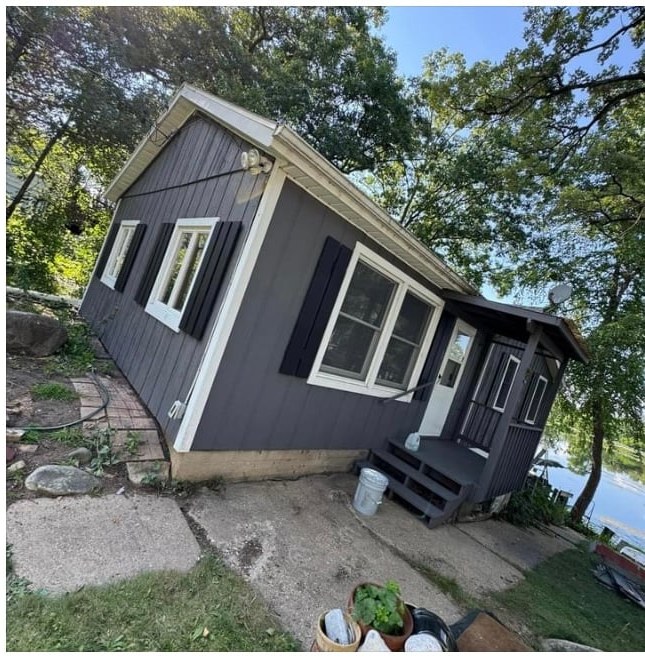 Home exterior after repaint — fresh charcoal finish