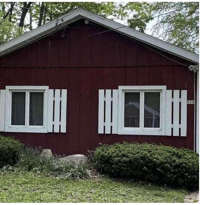 Home exterior before repaint — faded red siding
